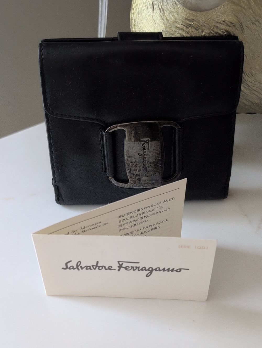 Salvatore Ferragamo Black Leather Wallet with Signature Buckle.